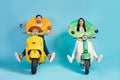 Full length photo of funky two people lady guy drive retro moped good mood spread legs crazy hold colorful life buoys