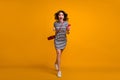 Full length photo of funny excited lady rush shopping read telephone sale season advertisement wear casual striped mini