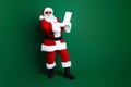 Full length photo of funny excited santa dressed red costume getting new year disobedient kids list empty space isolated