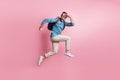 Full length photo of funny man dressed sweater rucksack jumping parachute looking far away isolated pink color Royalty Free Stock Photo