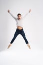 Full-length photo of funny man 30s in casual t-shirt and jeans jumping isolated over white background. Royalty Free Stock Photo