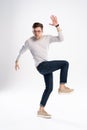 Full-length photo of funny man 30s in casual t-shirt and jeans jumping isolated over white background. Royalty Free Stock Photo