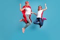 Full length photo of funny mom lady little daughter spend time together superhero win costume competition jump high up