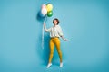 Full length photo of funny pretty lady walking surprise birthday party hold many air balloons wear casual green shirt