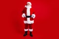 Full length photo of good mood santa claus fairy charcter look up empty space special new year offer isolated on red