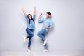 Full length photo of guy and lady celebrating best victory raising fists air wear casual jeans clothes isolated grey