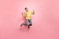 Full length photo of handsome guy jumping high enjoy summer time showing v-sign symbols wear hipster striped shirt