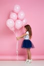 Child girl posing with pastel pink air balloons Royalty Free Stock Photo