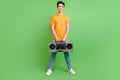 Full length photo of happy charming man hold hands boombox music lover isolated on green color background