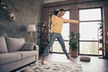 Full length photo of happy crazy cheerful afro american woman jump up win talk phone indoors inside house home Royalty Free Stock Photo