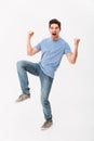 Full-length photo of happy man 30s in casual t-shirt and jeans r Royalty Free Stock Photo