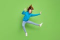 Full length photo of happy positive girl jump up fly hair fighter good mood sale isolated on green color background