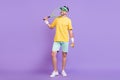 Full length photo of happy positive man look empty space wear tennis cap racket isolated on violet color background