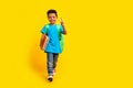 Full length photo of happy smiling preteen boy wear blue t-shirt walking school showing v-sign empty space Royalty Free Stock Photo