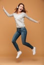 Full length photo of joyful pretty girl in casual wear jumping w