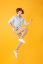 Full length photo of joyful young man 20s jumping and playing in Royalty Free Stock Photo