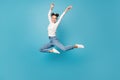 Full length photo of lady jump ballerina pose wear white pullover jeans sneakers isolated blue color background