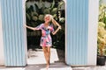 Full-length photo of lovable tanned lady wears summer attire. Portrait of barefooted young female m