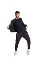 Full-length photo of a funny guy dancing in studio isolated on white background. Royalty Free Stock Photo