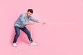 Full length photo of motivated guy ready pull string compete tug war isolated on pastel color background Royalty Free Stock Photo