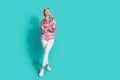 Full length photo of nice young lady folded arms look empty space wear trendy pink print garment on cyan color