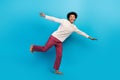Full length photo of nice young male hands plane wings have fun wear trendy white pajama garment isolated on blue color Royalty Free Stock Photo