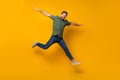 Full length photo of nice young male jump fly spread hands plane wear trendy khaki garment isolated on yellow color Royalty Free Stock Photo