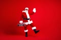 Full length photo of optimistic santa claus in sunglass waving palm say hello hold boombox dancing isolated on red color Royalty Free Stock Photo