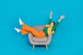 Full length photo of overjoyed carefree person sit chair have fun good mood isolated on blue color background