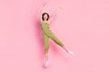 Full length photo of overjoyed lady dressed khaki outfit raise hand good mood free time dance empty space  on Royalty Free Stock Photo