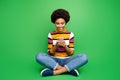 Full length photo of positive afro american girl blogger sit legs crossed folded use cellphone post comment share repost