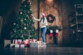 Full length photo of positive cheerful girl want prepare for x-mas party celebration hang balls toys on christmas Royalty Free Stock Photo