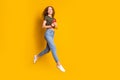 Full length photo of positive funky cute girl running hurrying device shop sale empty space isolated on yellow color Royalty Free Stock Photo