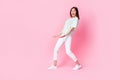 Full length photo of positive optimistic lady striped stylish clothes hold empty space glad big sales isolated on pink