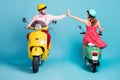 Full length photo of positive two people man woman ride motor bike enjoy fast speed race success team work hold hand Royalty Free Stock Photo