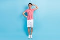 Full length photo of powerful happy cheerful guy show biceps isolated on pastel blue color background