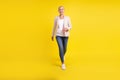 Full length photo of pretty aged woman go walk meeting agent manager isolated over yellow color background
