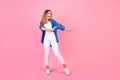 Full length photo of pretty carefree girl wear blue shirt enjoying discotheque empty space isolated pink color Royalty Free Stock Photo