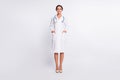 Full length photo of pretty charming young lady physician dressed uniform running standing arms pockets isolated white