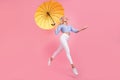 Full length photo of pretty dreamy girl dressed blue top jumping high holding umbrella empty space  pink color Royalty Free Stock Photo