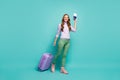 Full length photo of pretty funny lady walk airport documents registration with tickets rolling trip suitcase wear lilac