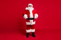 Full length photo of retired old man grey beard self-assured hands hips christmas tree event wear santa costume gloves Royalty Free Stock Photo