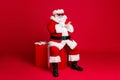 Full length photo of retired old man white beard hold telephone sit large box what chatting elf friend wear x-mas santa Royalty Free Stock Photo