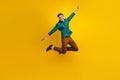 Full length photo of satisfied man flying air rejoicing celebrating black friday isolated on yellow color background