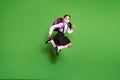 Full length photo of schoolgirl pigtails running jumping wear mask backpack isolated on vivid green colored background