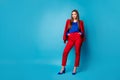 Full length photo of self-confident pretty business lady bossy standing hold hands in pockets wear red suit blouse