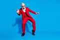 Full length photo of senior man wealthy happy positive smile have fun party wear suit isolated over blue color Royalty Free Stock Photo
