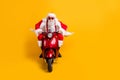 Full length photo of serious santa claus in red hat drive his modern motorbike ride north-pole for christmas x-mas