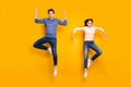Full length photo of serious team married couple jump raise hands dance like humanoid robots wear stylish modern clothes