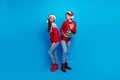 Full length photo of shiny cute women santa elves wear ornament pullovers dancing x-mas event isolated blue color
